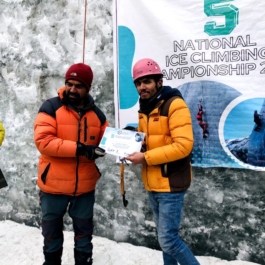 Fareed receiving a certificate at the National Ice Climbing Championship