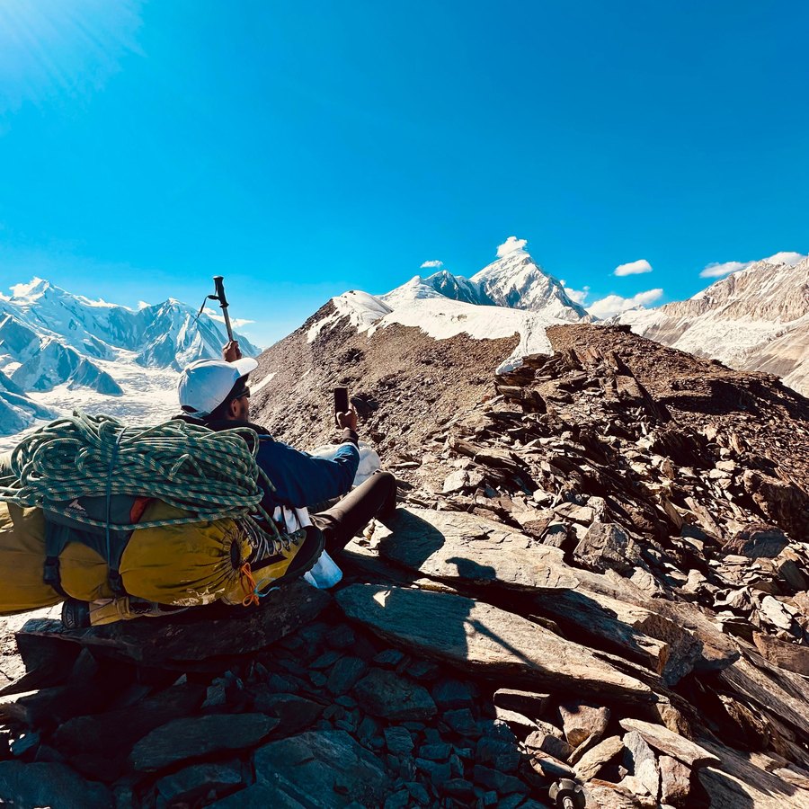 Sitting on rocks looking toward a big snow peak