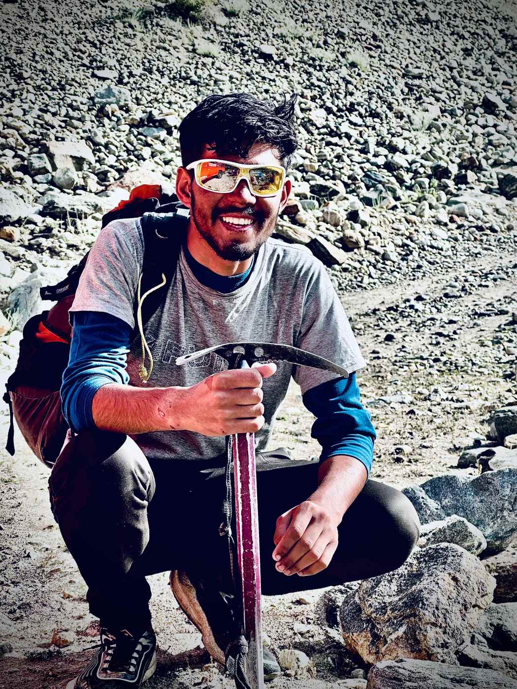 Fareed Hussain on a climb, holding an ice axe