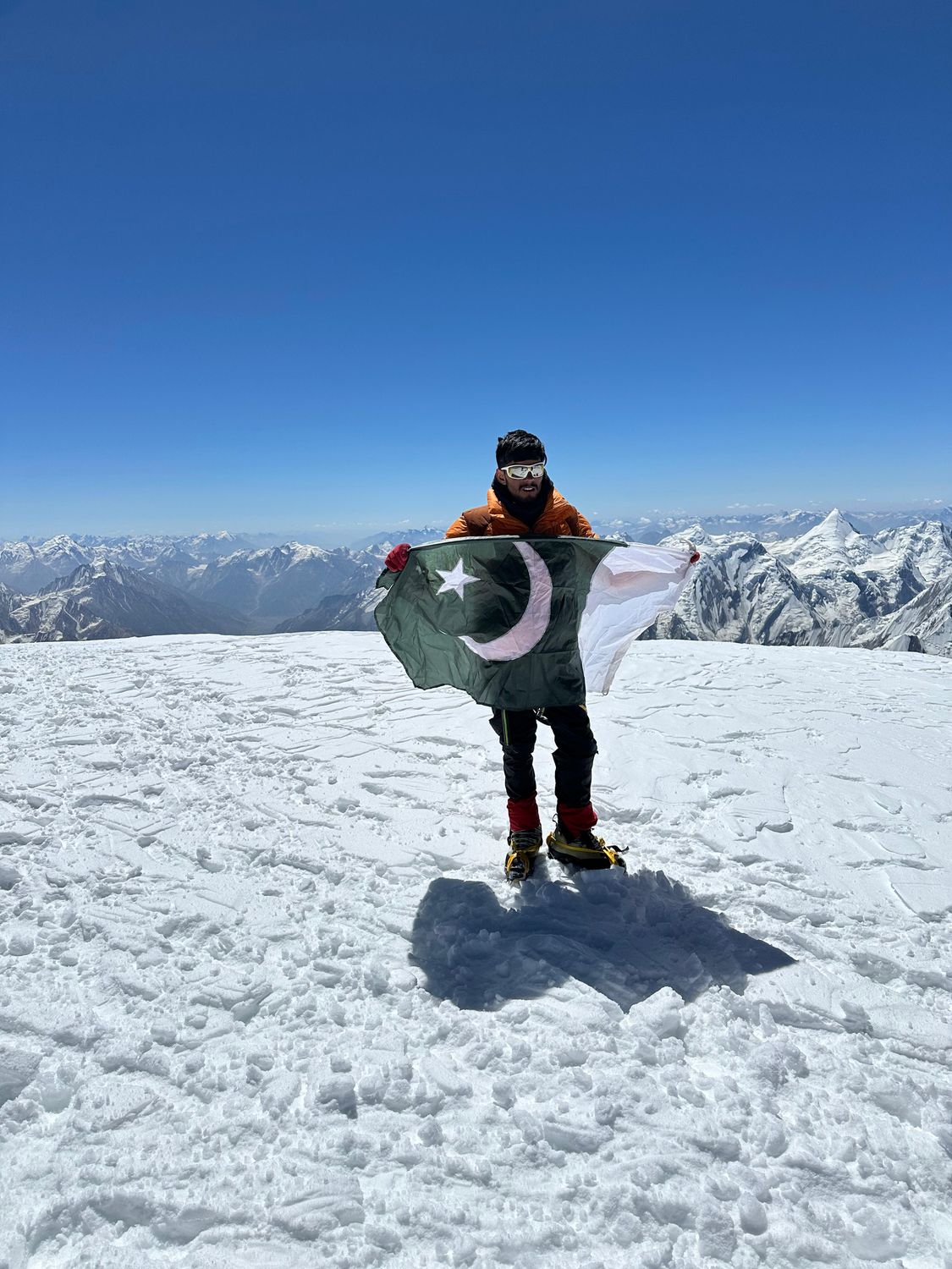 Fareed on a summit with the Pakistan flag